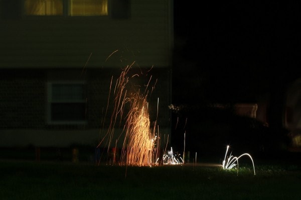 Ground-based fireworks in a black sky.