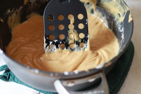 Melted marshmallows mixed with peanut butter in a pot.