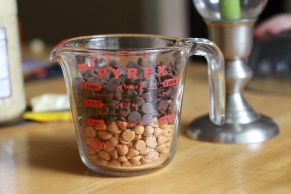 Chocolate and butterscotch chips in a measuring cup.