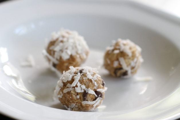 Chocolate chip peanut butter energy balls on a white plate.