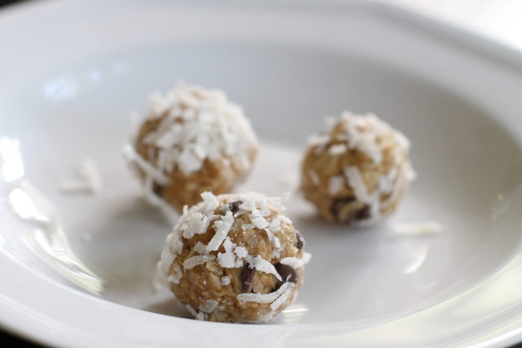 Three energy balls, rolled in coconut.