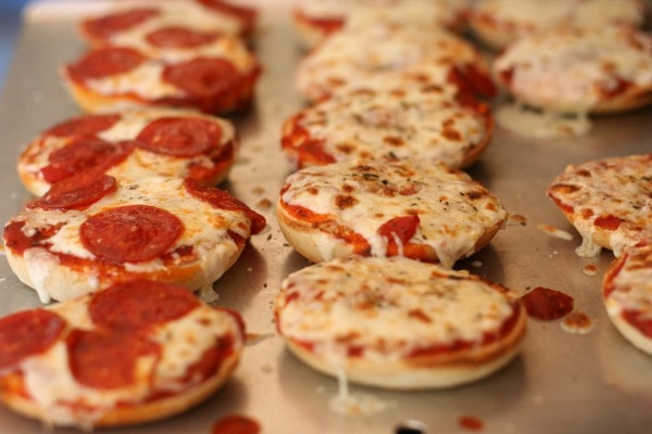 pizza bagels on a baking sheet.