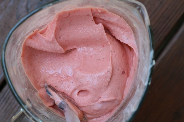 A pink smoothie in a blender jar.