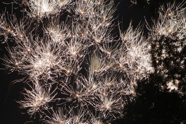 A whole group of white fireworks exploding.