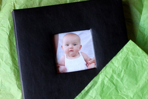 A scrapbook surrounded by tissue paper.