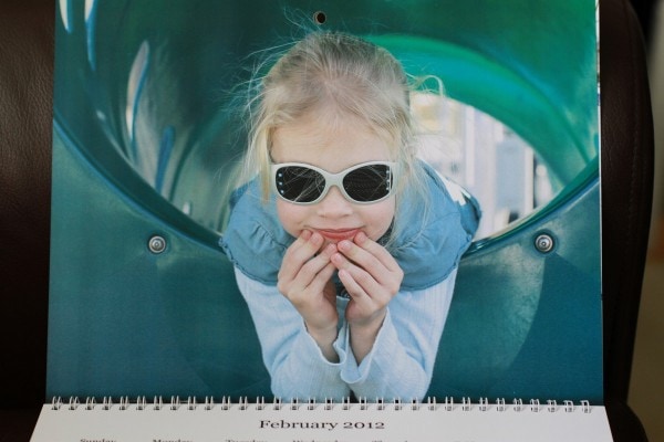 Sonia in a green playground slide.