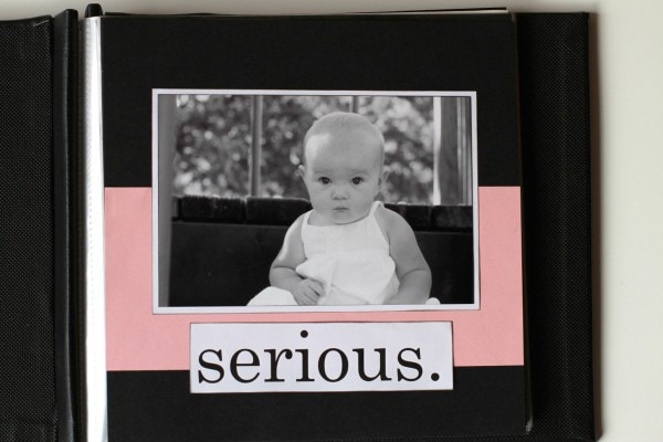 A black and white scrapbook page of a baby girl.