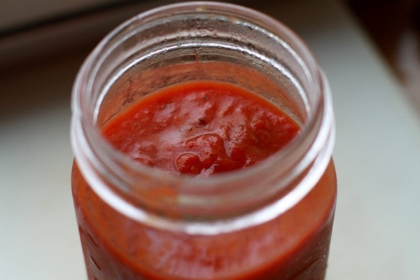 glass mason jar of tomato sauce.