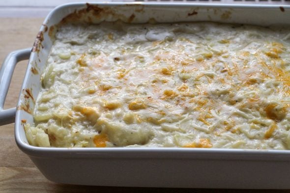 a white pan of scalloped potatoes.