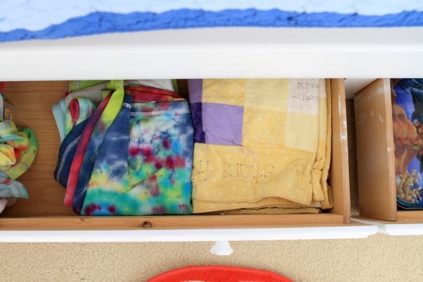 A drawer filled with blankets.
