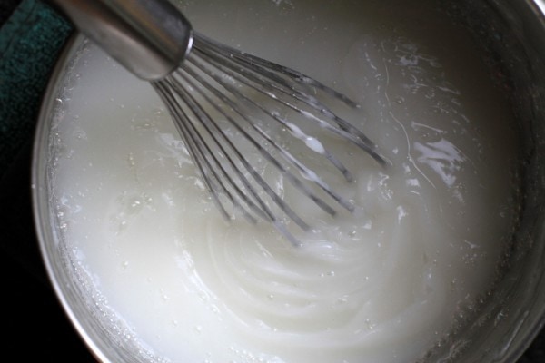 A whisk in a pot.