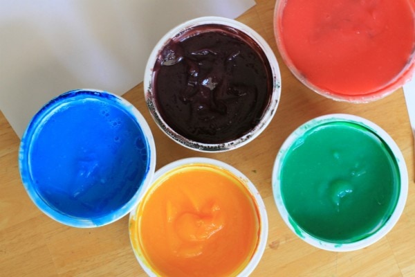 Colorful pots of finger paint.