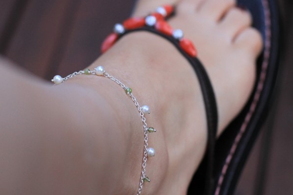 A person wearing an anklet.