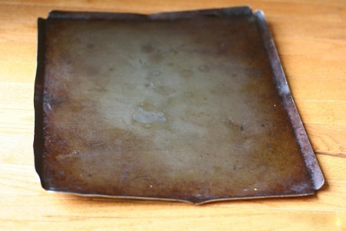 A worn nonstick cookie sheet