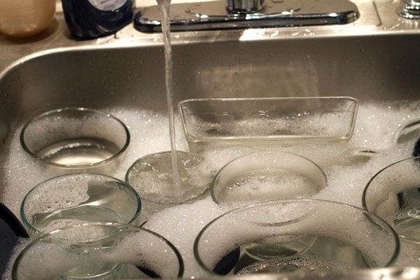 a sink full of pyrex dishes.