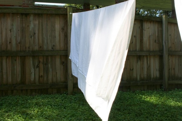 A white bedsheet on a clothesline.