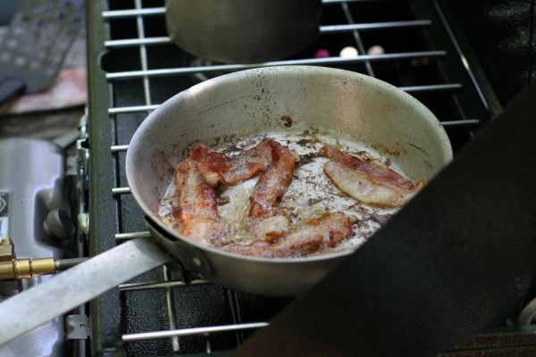 Bacon cooking on a campstove.