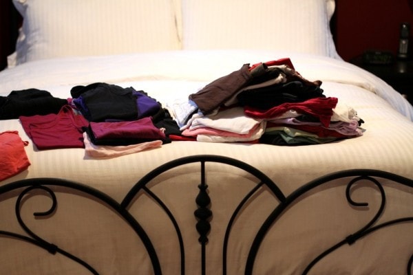 Clothes folded on a bed.