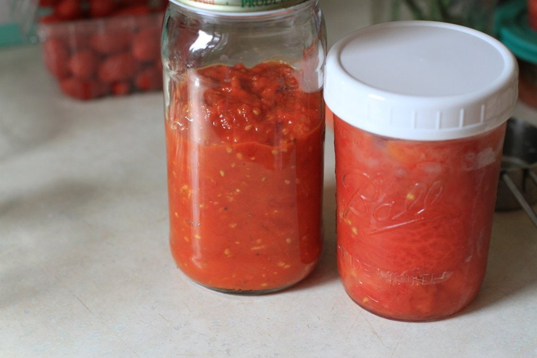 Two glass jars of tomato sauce.