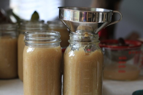 funnel filling applesauce jars