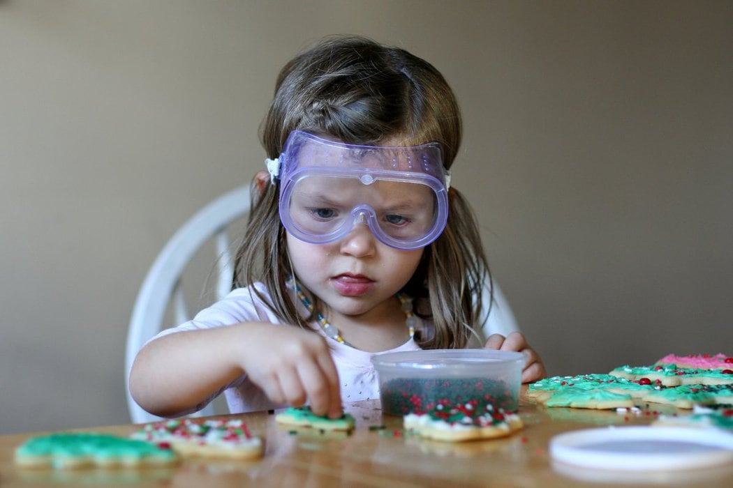 Zoe wearing goggles to decorate cookies.