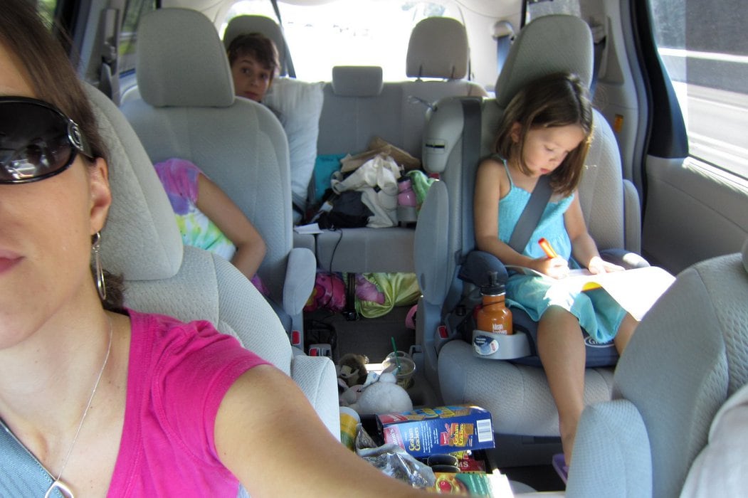 Kristen takign a selfie in her van on a road trip.