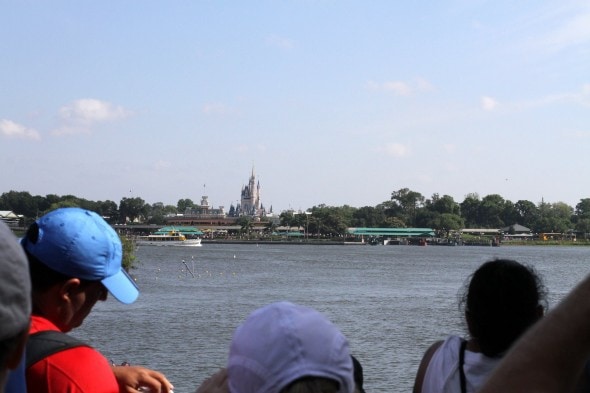 A view of Disney Magic Kingdom from a boat.