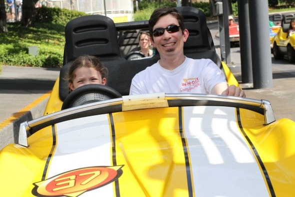 Mr. FG and Zoe in a Disney race car.