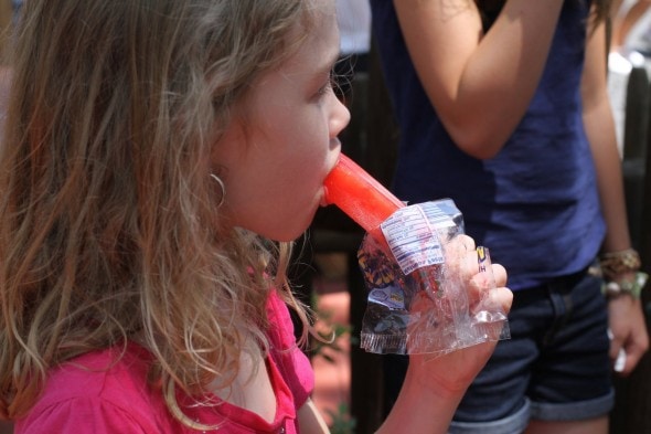 Sonia eating a popsicle at Disney.