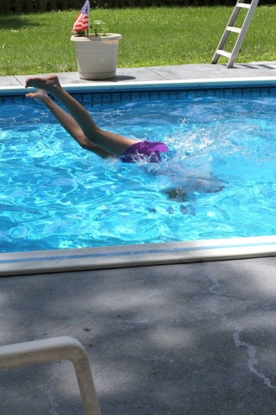 A girl diving into a pool.