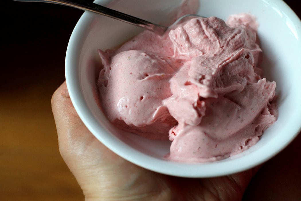 Strawberry banana ice cream in a white bowl.