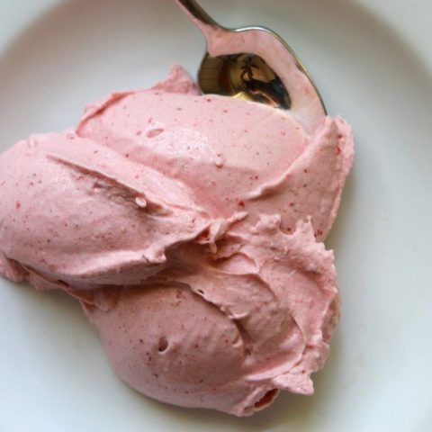 Strawberry banana ice cream in a white dish.
