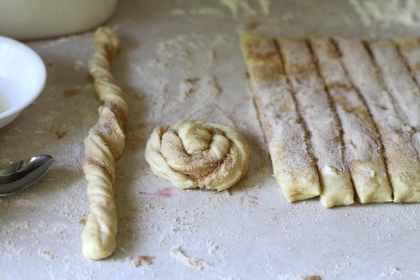 sweet roll dough being shaped into spiral sweet rolls.