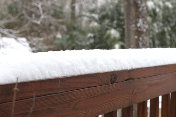 snowy deck railing