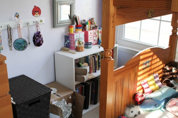 A tidied child's bedroom with a bunkbed in view.