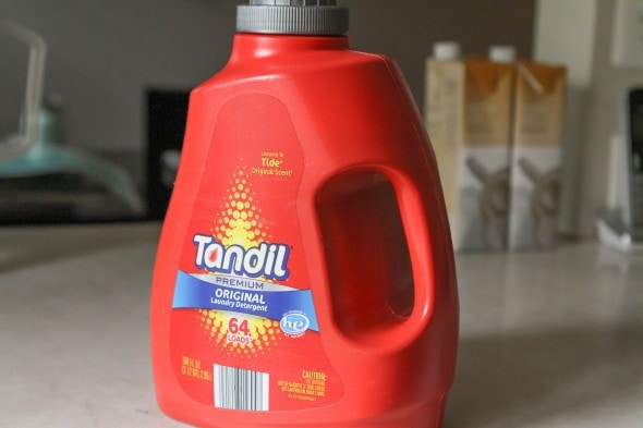 An orange bottle of Aldi laundry soap.