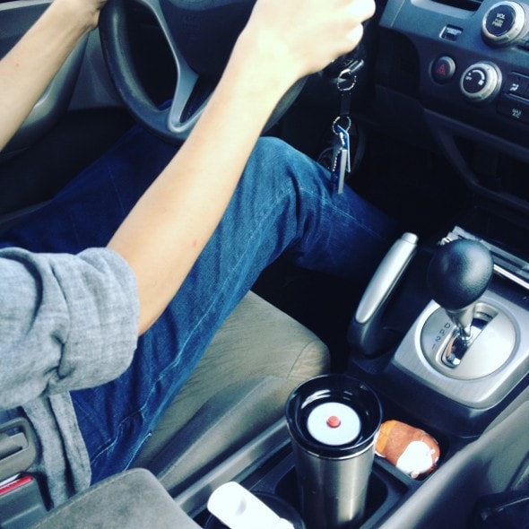 A teenager driving a car.