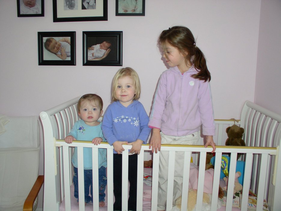 Three girls in a crib