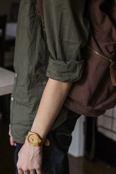 A lanky teen wearing a brown backpack.