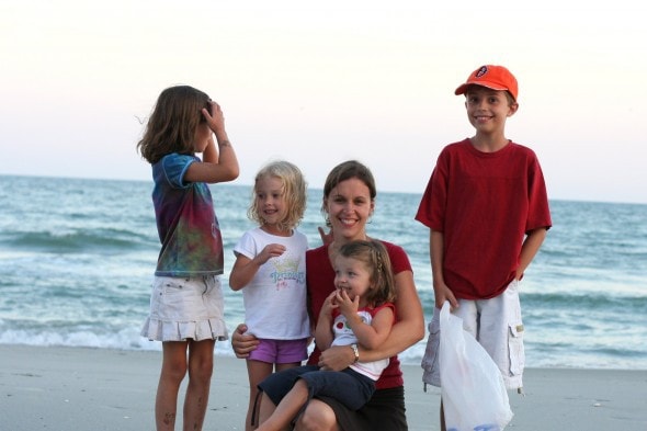 Kristen with her kids on a beach.