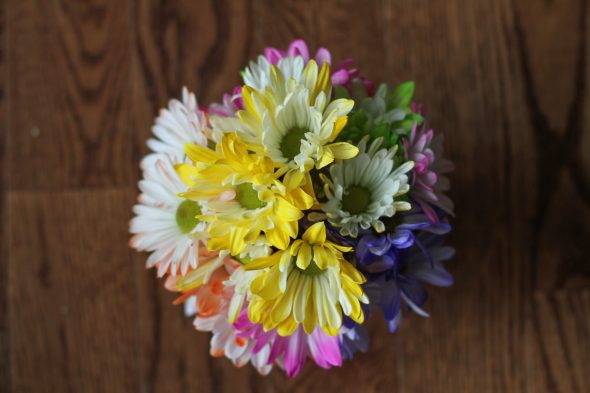 A view of colorful flowers on a wooden background.