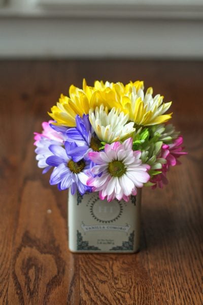 Colorful flowers in a Harney tea tin.