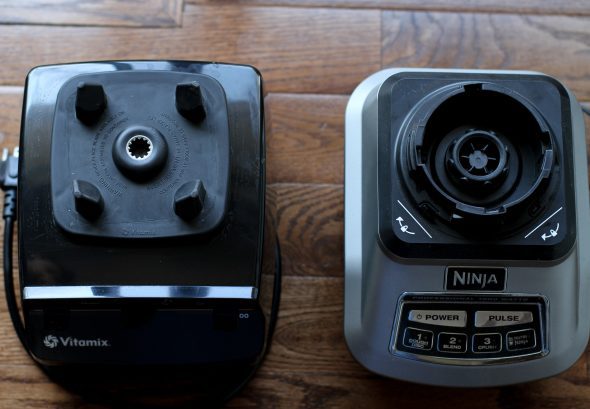 A Ninja and a Vitamix blender base next to each other.