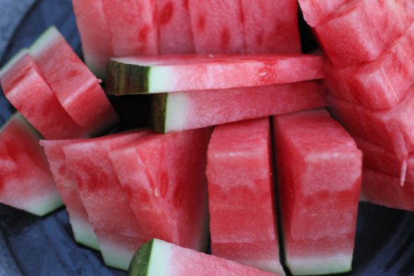 Watermelon slices on a black plate