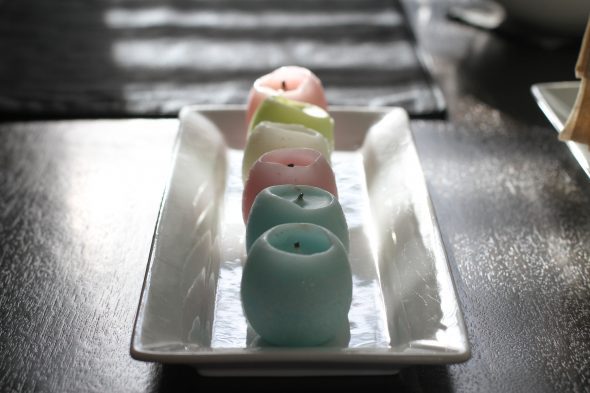 easter egg candles on a white plate.