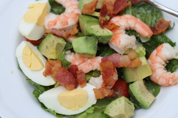 Shrimp cobb salad in a white bowl.