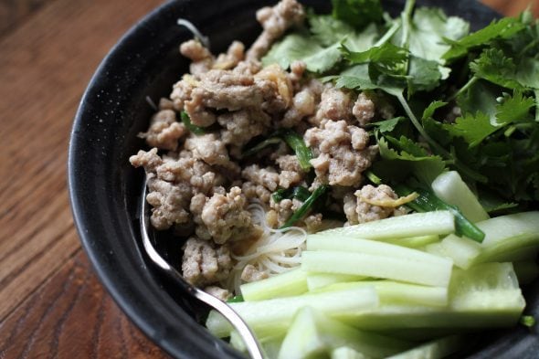 Pork noodle bowls in a black bowl.