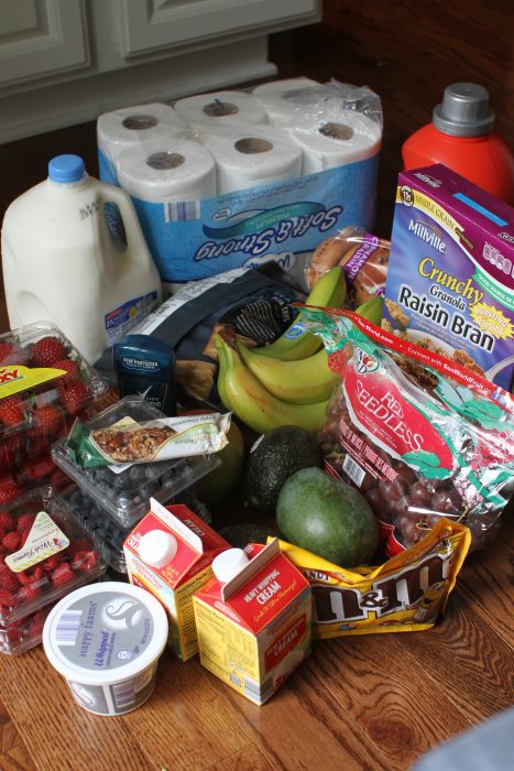 A pile of Aldi groceries on a kitchen floor.