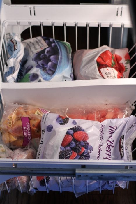 Frozen fruit in a freezer drawer.
