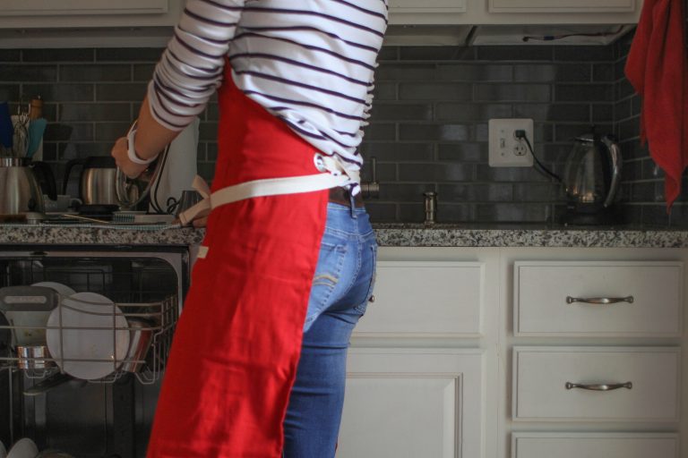 Kristen in a red apron.